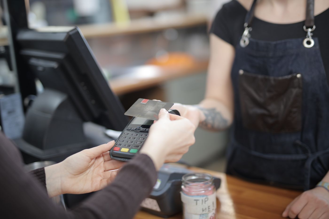 A patient paying by card at a counter