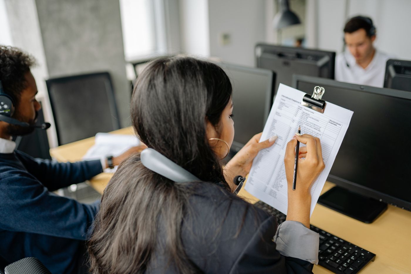 An officer checking a form at a desk computer