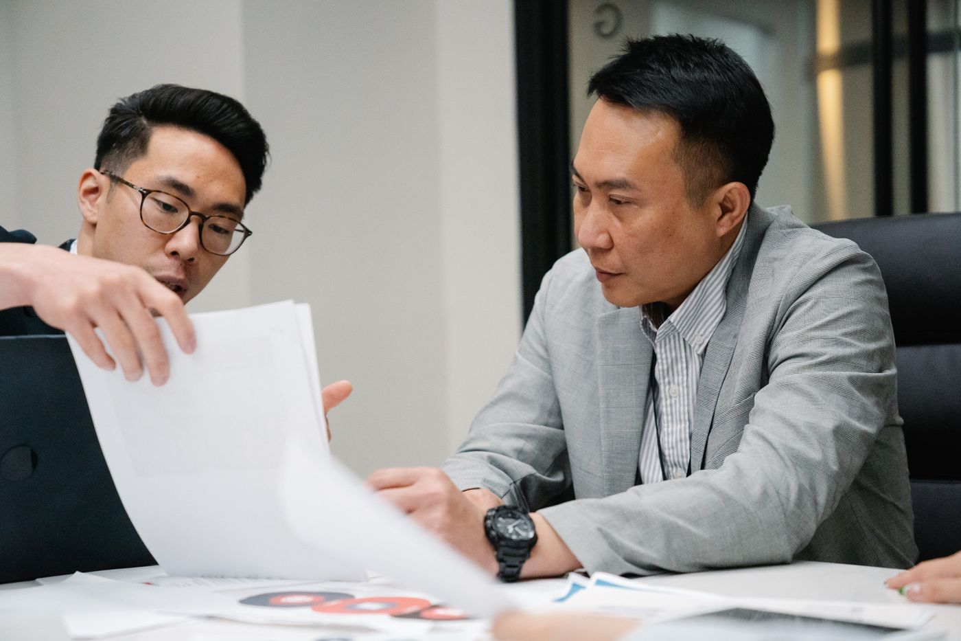 Two managers reviewing a document together